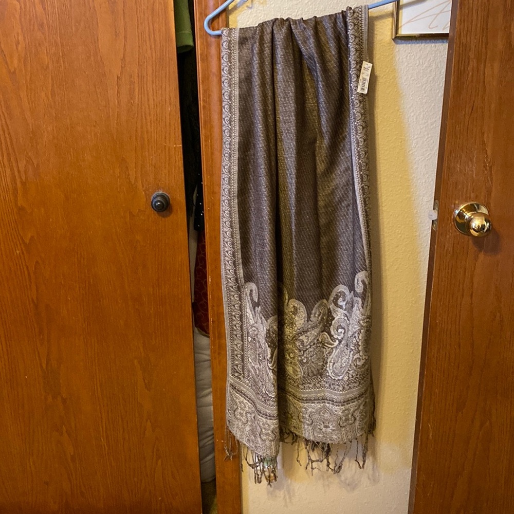 Very pretty scarf. Never used. 27 wide by 70 inches long with fringe on bottom.